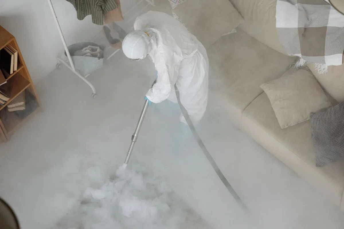 Biohazard cleanup technician in protective equipment, Peabody, KS